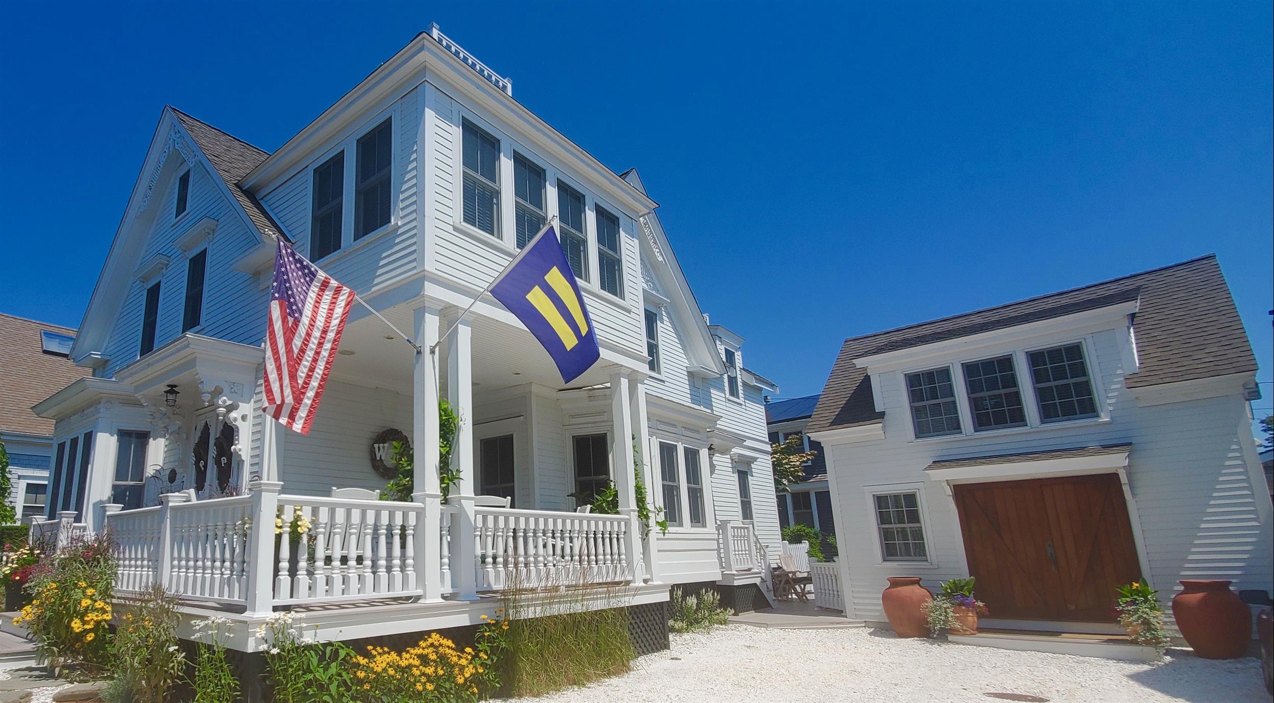 The porch, main house, and carriage house at White Porch Inn 